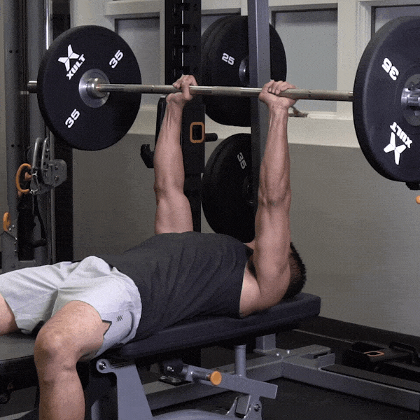 Animation of a man doing a close-grip barbell bench press, lowering the bar to his chest and pressing it back up